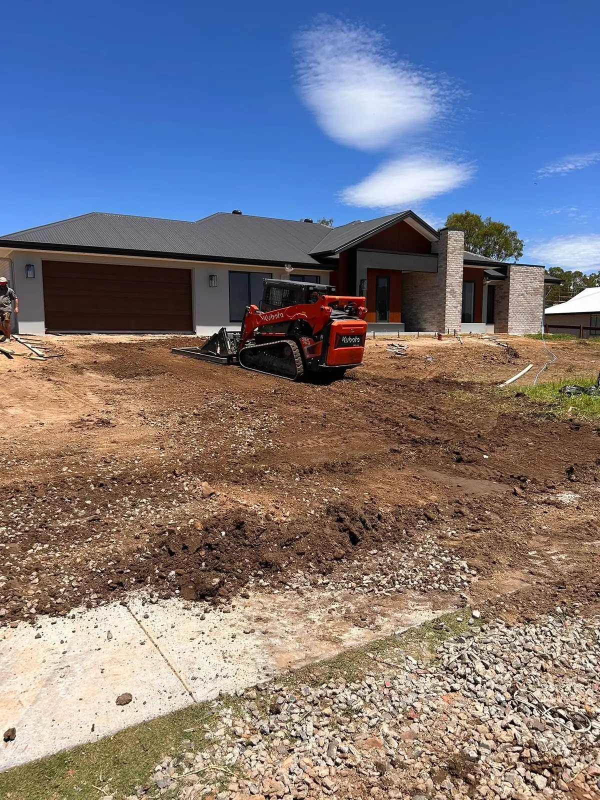 Track loader levelling a driveway base