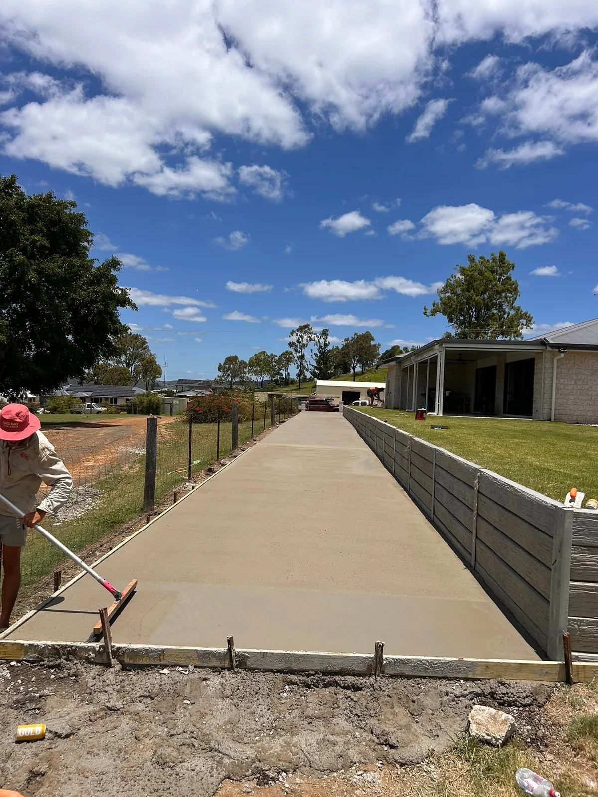 Crew member screeding a fresh driveway