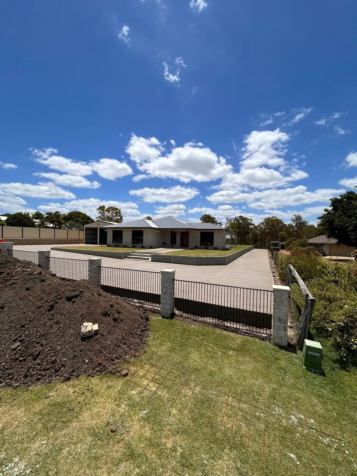 Finished concrete driveway wrapping around a brick home