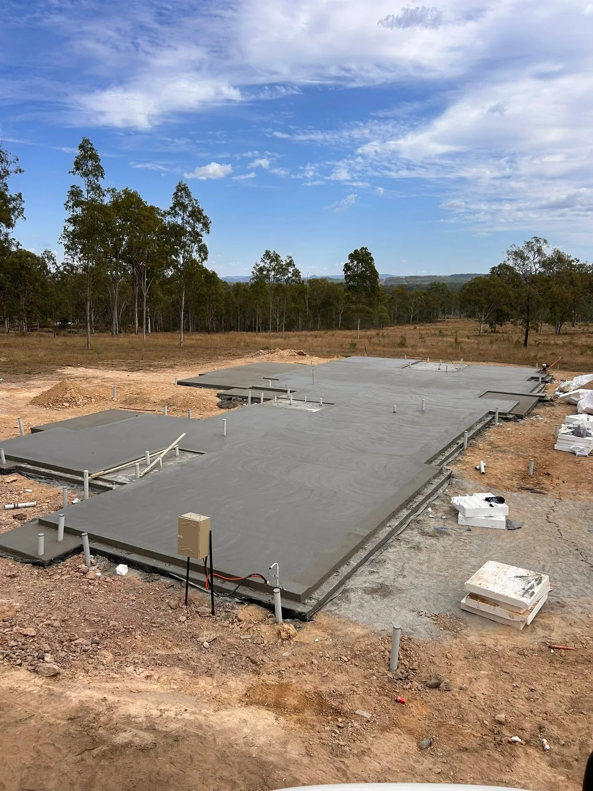House slab with gum trees behind
